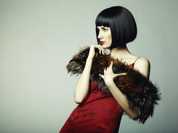 Fashion portrait of a young beautiful dark-haired woman - 写真・画像
