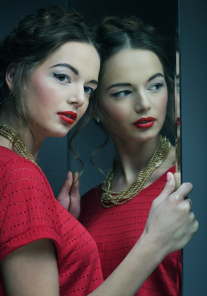 beautiful  girl female model with bright makeup  and her reflect - 写真・画像