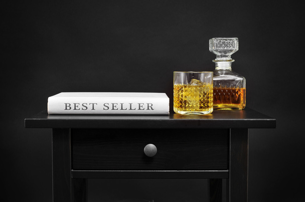 bottle with liquor and book with the text best seller - Photo, Image