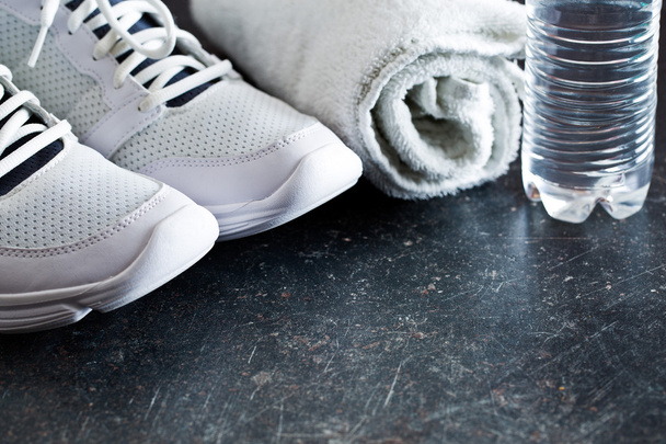 sport concept. towel, shoes and water in bottle - Fotoğraf, Görsel