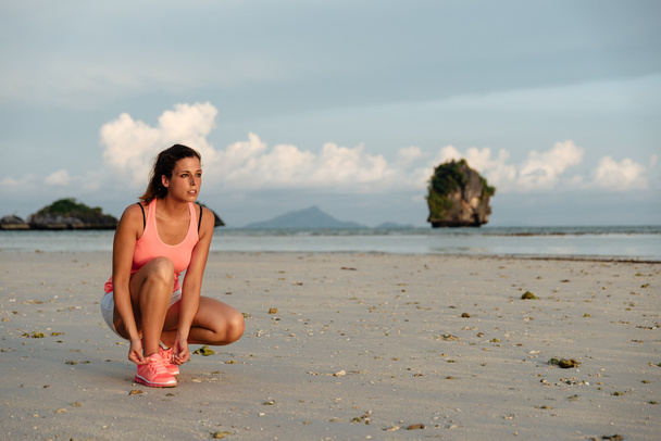 Female athlete ready for running at beach - Foto, afbeelding