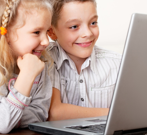 Happy kids playing laptop at home - Φωτογραφία, εικόνα