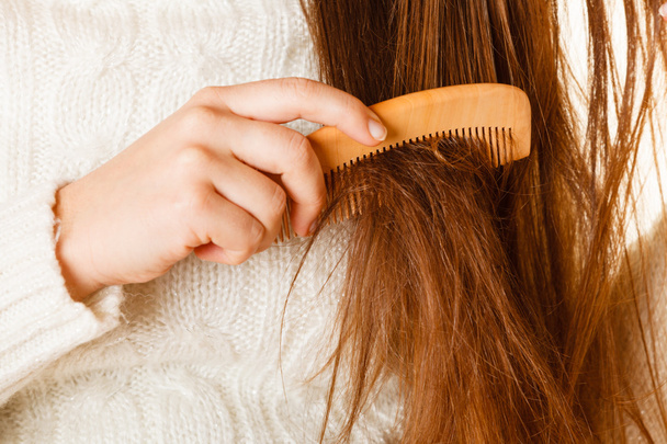 Woman combing hair - Фото, зображення