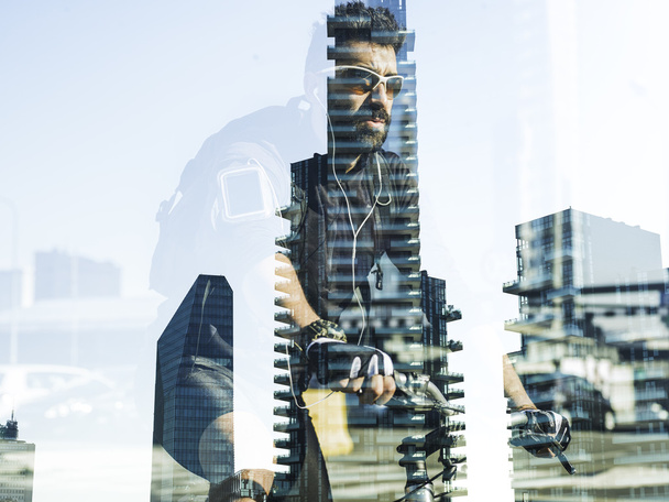 Double exposure of biker and cityscape - Photo, image