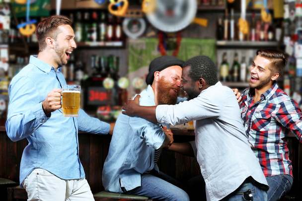 Young men in bar - Фото, зображення