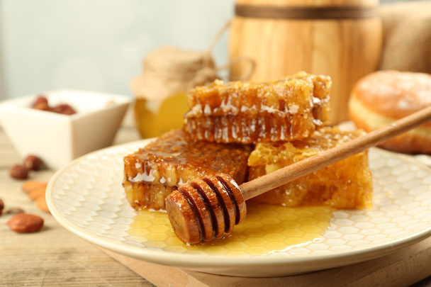 Honeycombs on plate on wooden background - Valokuva, kuva