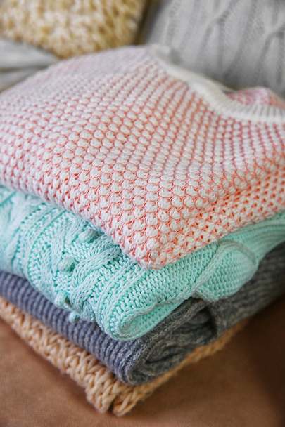 Knitted clothes on a sofa - Foto, Imagen