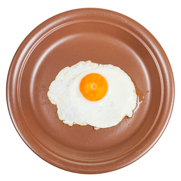 vista superior de huevo frito en plato marrón aislado
 - Foto, imagen