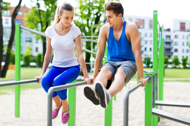 Young couple training outdoors - 写真・画像