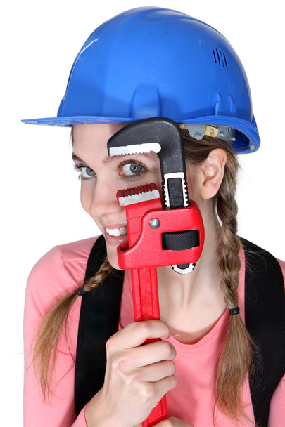 Funny female laborer with wrench - Foto, afbeelding