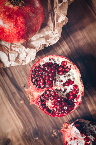 Pomegranates on a wooden background - Foto, afbeelding