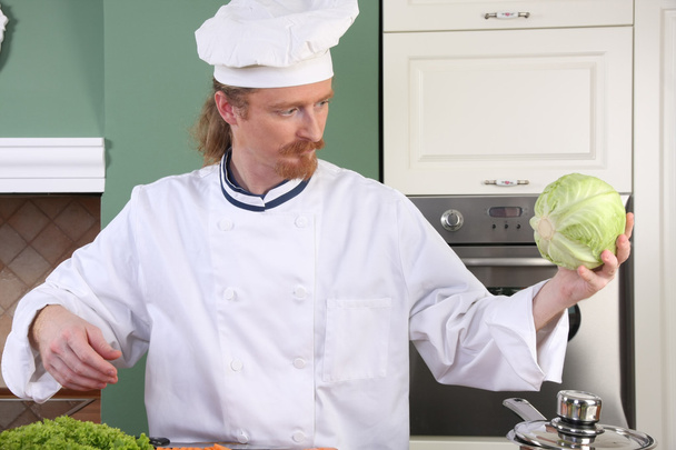 Young chef preparing lunch in kitchen - Fotografie, Obrázek