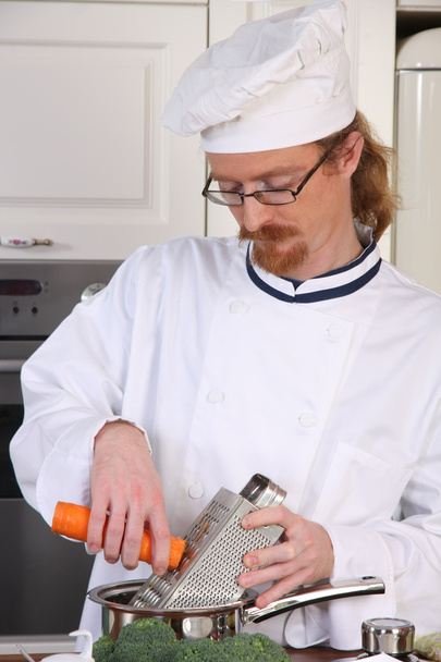 Young chef preparing lunch in kitchen - Photo, Image