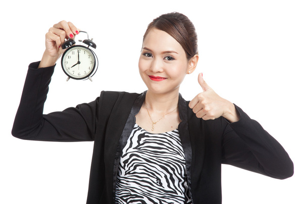 Young Asian business woman show thumbs up with a clock - Foto, immagini