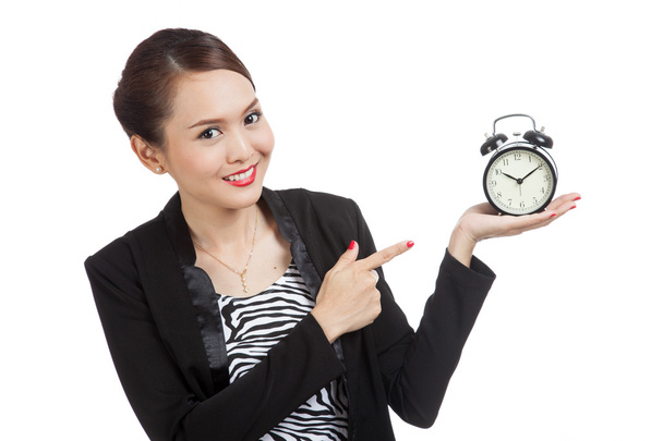 Young Asian business woman point to a clock - Foto, imagen