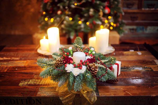 Fir branches decorated for the new year on dark wooden background. Christmas tree and candles, festive mood - Foto, Imagem