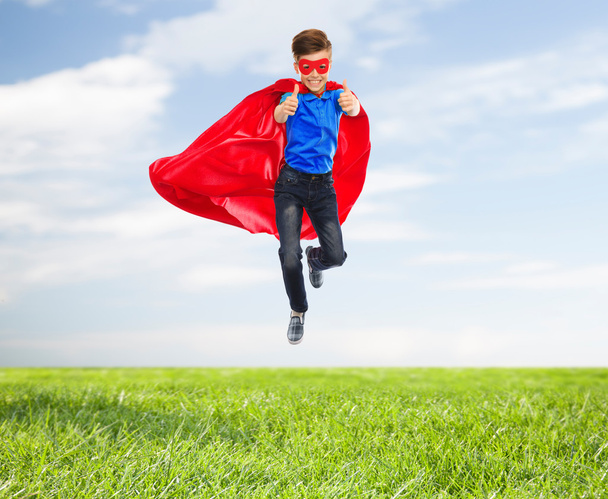boy in super hero cape and mask showing thumbs up - Фото, зображення