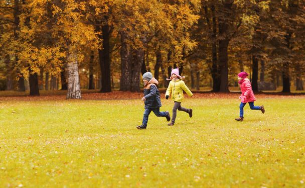 group of happy little kids running outdoors - Foto, afbeelding
