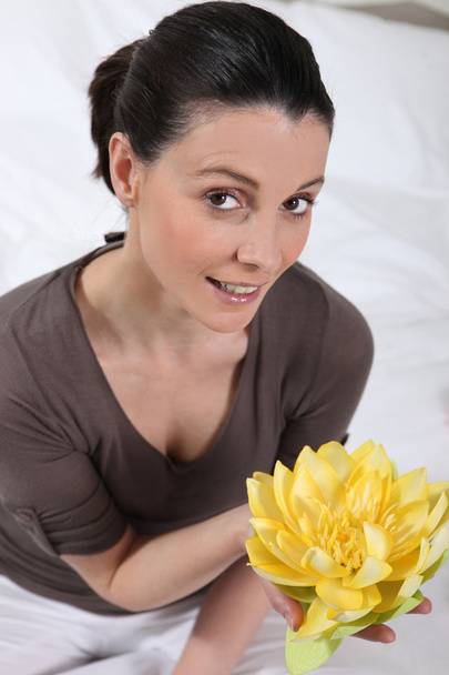 Woman holding a flower - Φωτογραφία, εικόνα
