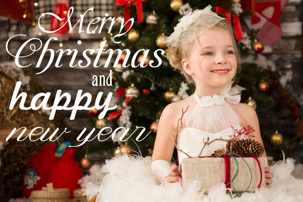 Cute Young beautiful girl in white Christmas dress is taking Chr - Photo, image