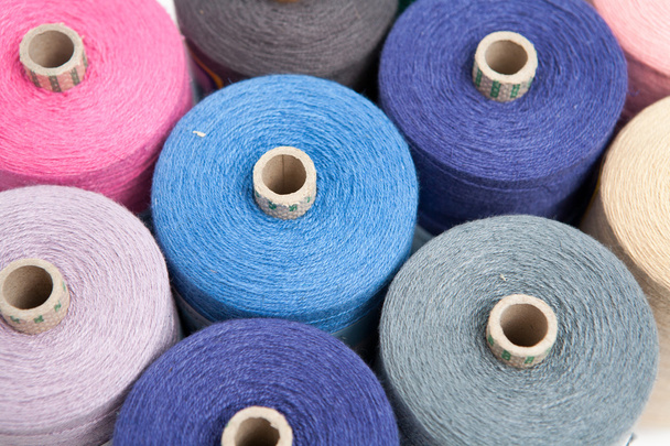 Blue sewing threads as a color background close up - Фото, изображение