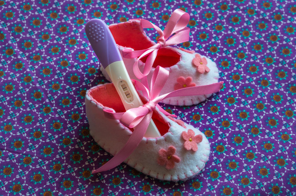 Newborn baby girl booties and pregnancy test - Photo, Image