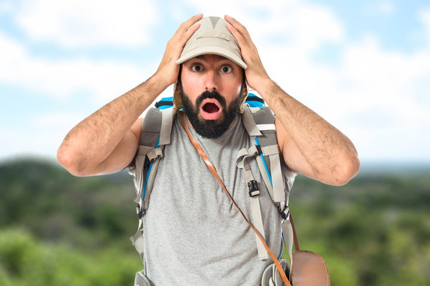 Backpacker doing surprise gesture over white background - Foto, immagini