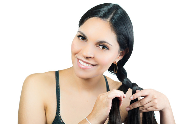 Beautiful young brunette girl braiding hair - Photo, Image