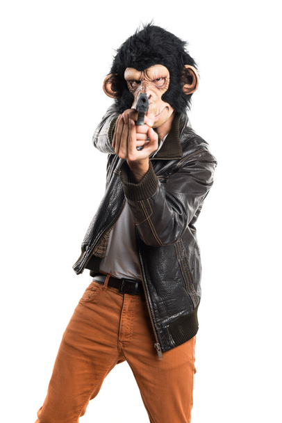 Μαϊμού άνθρωπος που κρατά ένα πιστόλι - Φωτογραφία, εικόνα