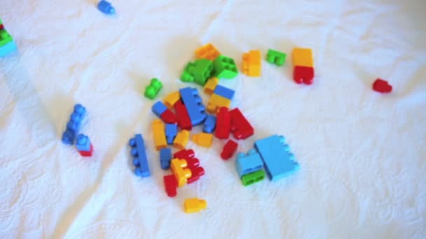 Cure toddler girl playing with colorful blocks - Footage, Video