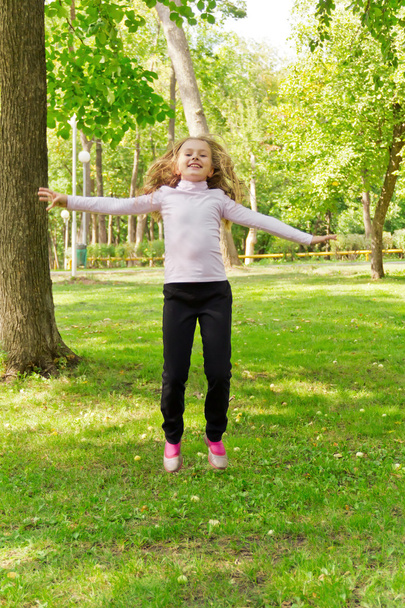 Jumping girl in summer - Фото, зображення
