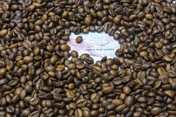 Map of Papua New Guinea under a background of coffee beans - Fotó, kép
