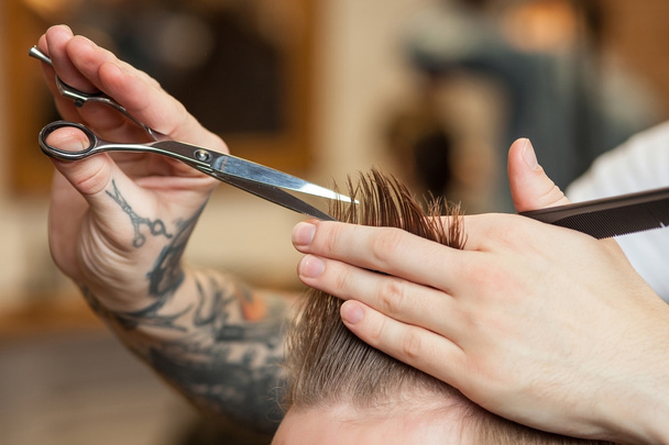 Skillful male barber is serving his customer - Fotoğraf, Görsel