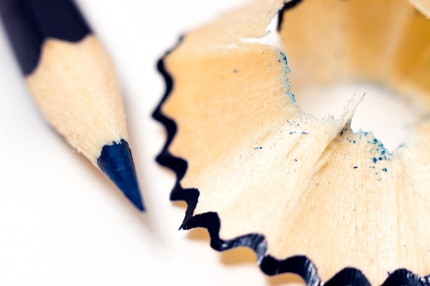 sharpened blue pencil sharpener with shavings on a white background - Φωτογραφία, εικόνα