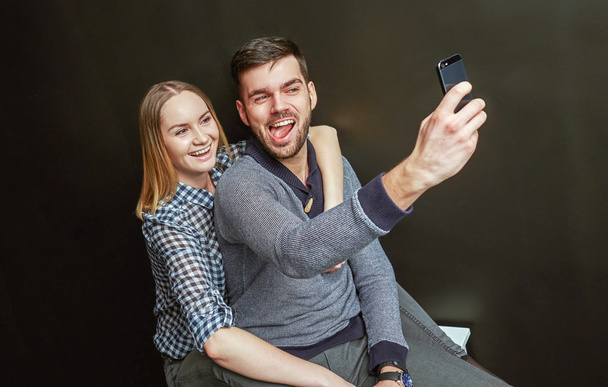 Couple making a funny selfie - 写真・画像