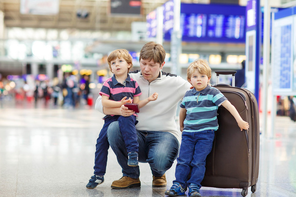 Father and two little sibling boys at the airport - Фото, изображение