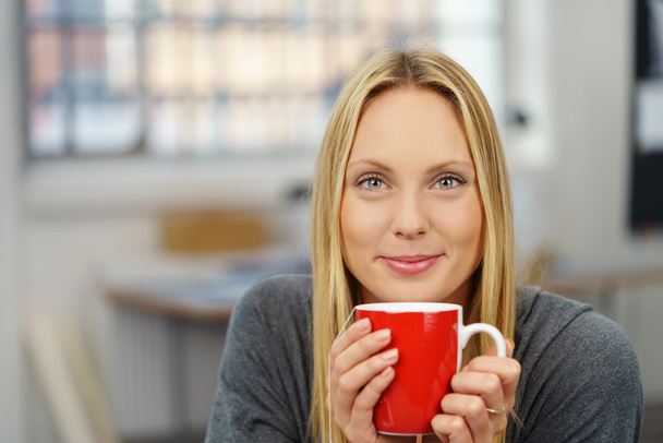 Attractive Woman with Cup of Tea Looking at Camera - Фото, изображение
