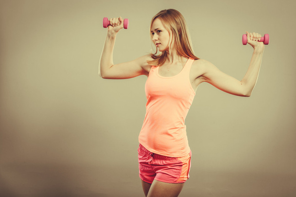Fitness woman exercising with dumbbells. - Fotoğraf, Görsel