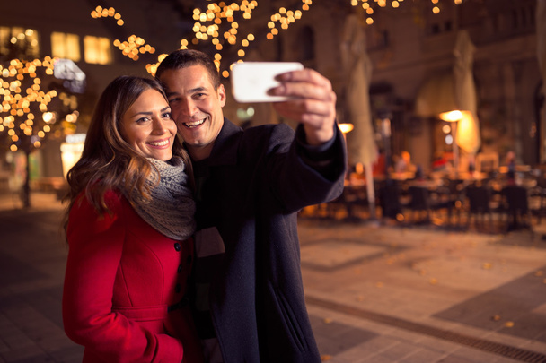 Happy young loving couple making selfie and smiling  - Photo, Image