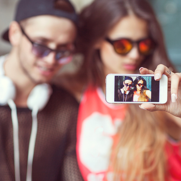 Young fashion couple taking selfie in the city - Фото, изображение
