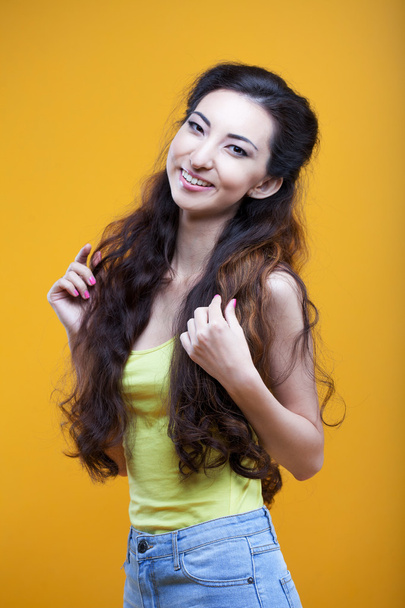 Fashion asian young  girl. Portrait on yellow background. - 写真・画像