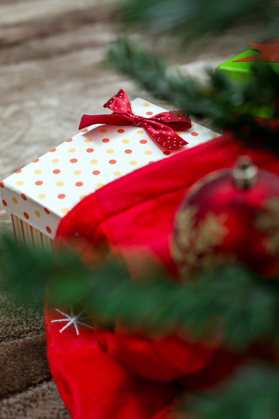 Christmas presents with red ribbon on dark wooden background in  - Φωτογραφία, εικόνα