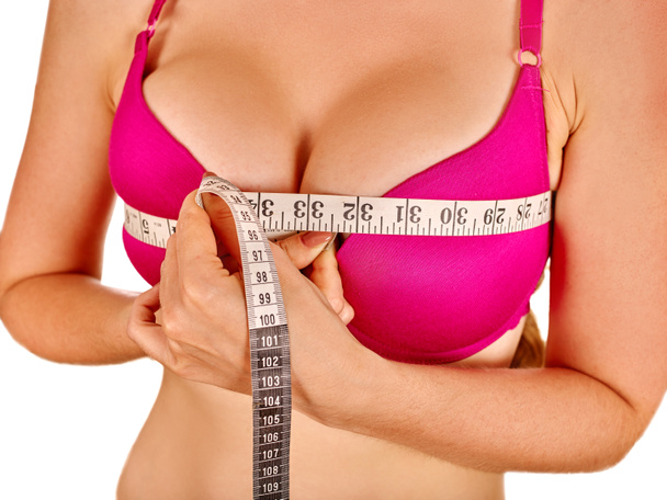 Girl wearing lingerie measures breast - Фото, зображення