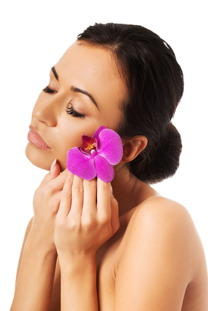Woman with purple orchid and closed eyes - Foto, Imagem