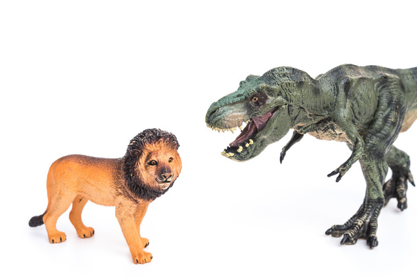 giocattoli tirannosauro e leone su sfondo bianco
 - Foto, immagini