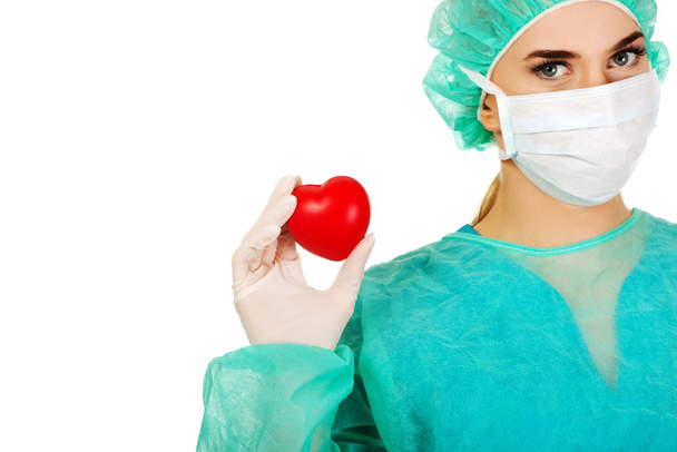 Female surgeon doctor holding heart - Photo, Image