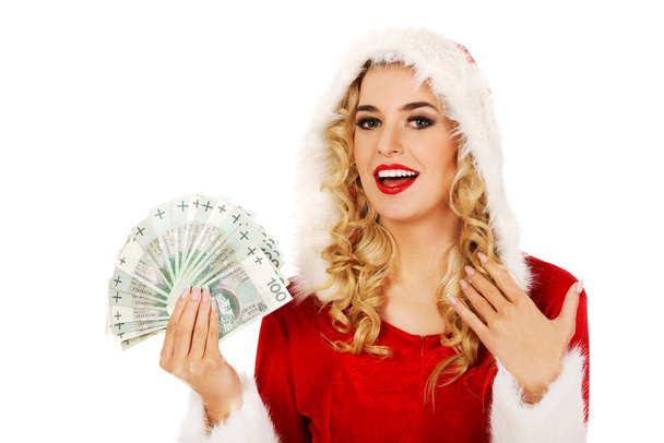 Beautiful santa woman holding a clip of polish money - Photo, image