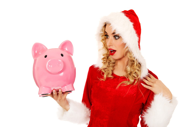 Surprised santa woman holding piggybank - Photo, Image