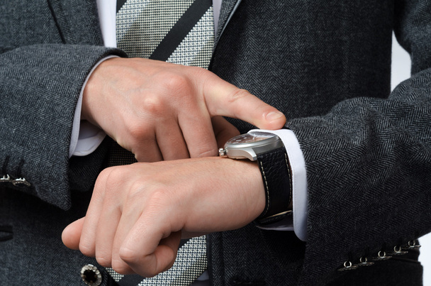 businessman watching time at their wristwatches - Zdjęcie, obraz