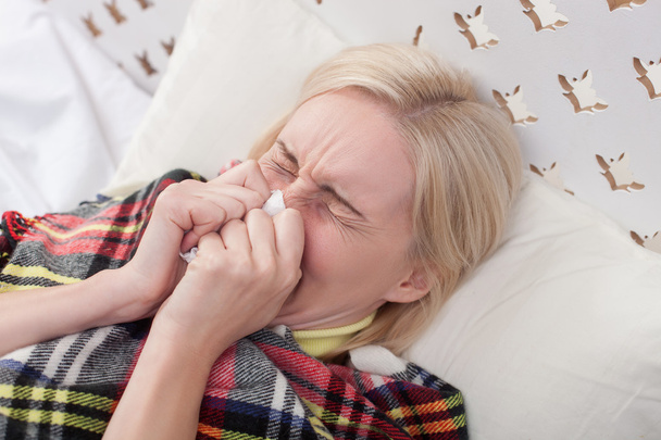 Sick young lady has caught a cold - Foto, afbeelding